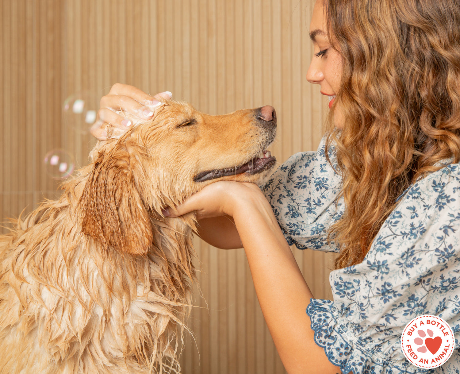 woman shampoos golden retriever with Skout's Honor Shampoo and conidtioner